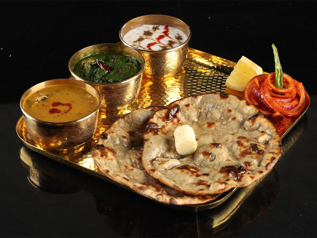 Tray serving nan bread and butter and indian dips