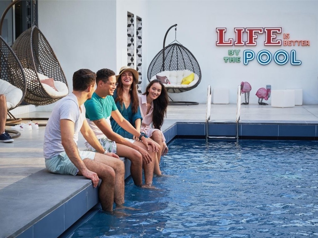 Group of people enjoying Life by the pool at hilton al seef